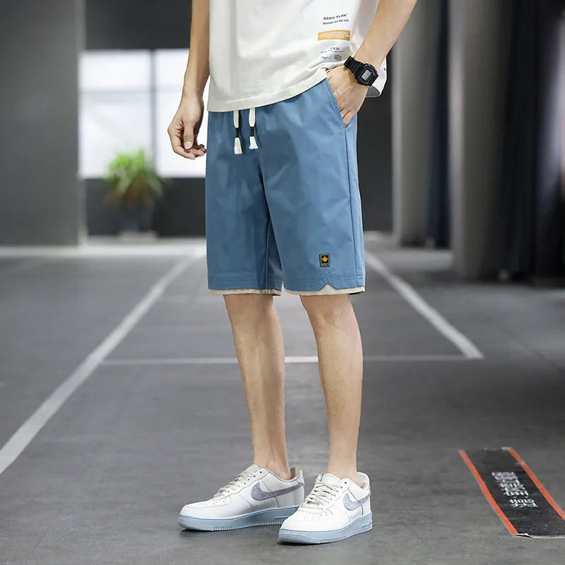 Casual polyester beach shorts with micro elasticity in Korean loose style, available in green, black, khaki and blue colours