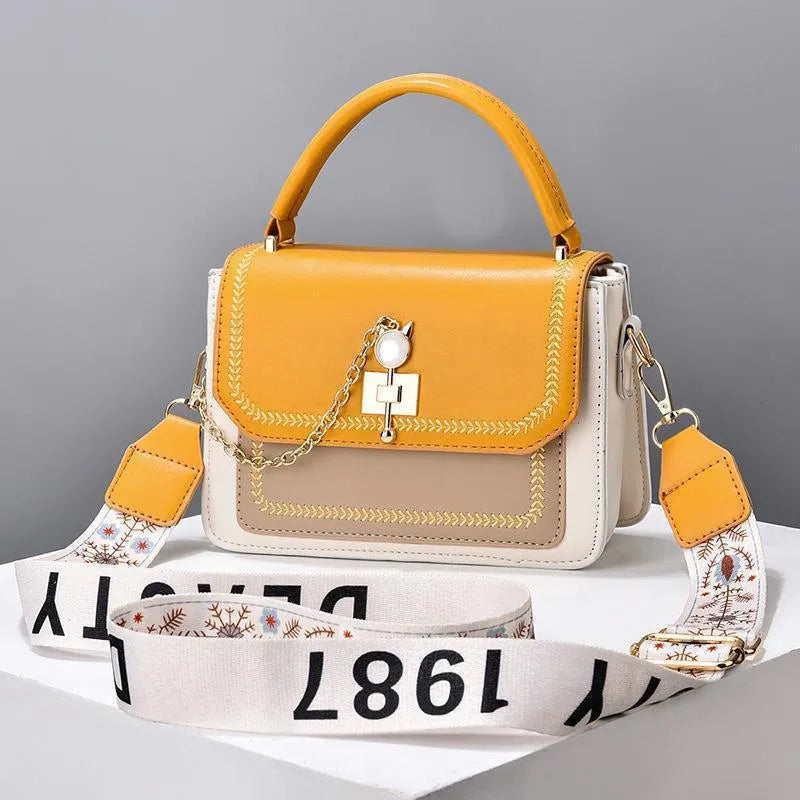 Large capacity PU shoulder bag with wide strap, embroidery detail, and contrast colour in black