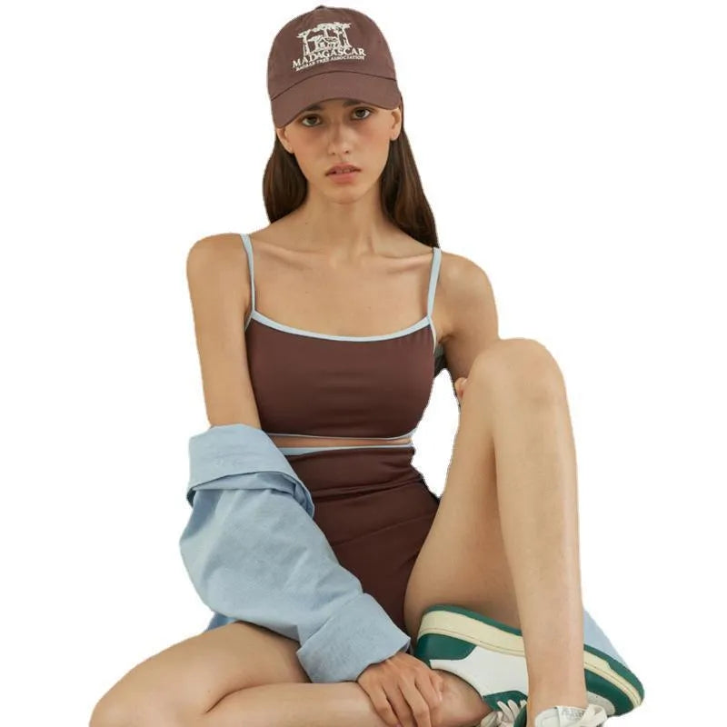 Brown women's triangle one-piece nylon swimsuit on a hanger.