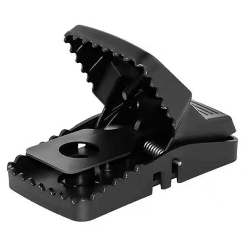 Automatic mouse cage trap with clear plastic dome and one-touch release lever at the base on a wooden floor.