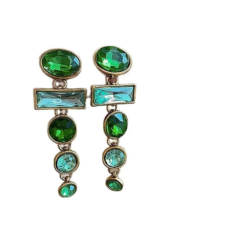 Green gradient tassel drop earrings with geometric alloy shapes and inlaid zircon stones on a white background.
