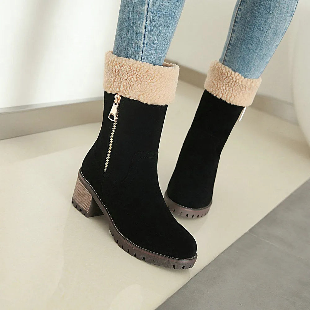 A pair of black snow boots with a plush lining and rubber insole on a winter background.