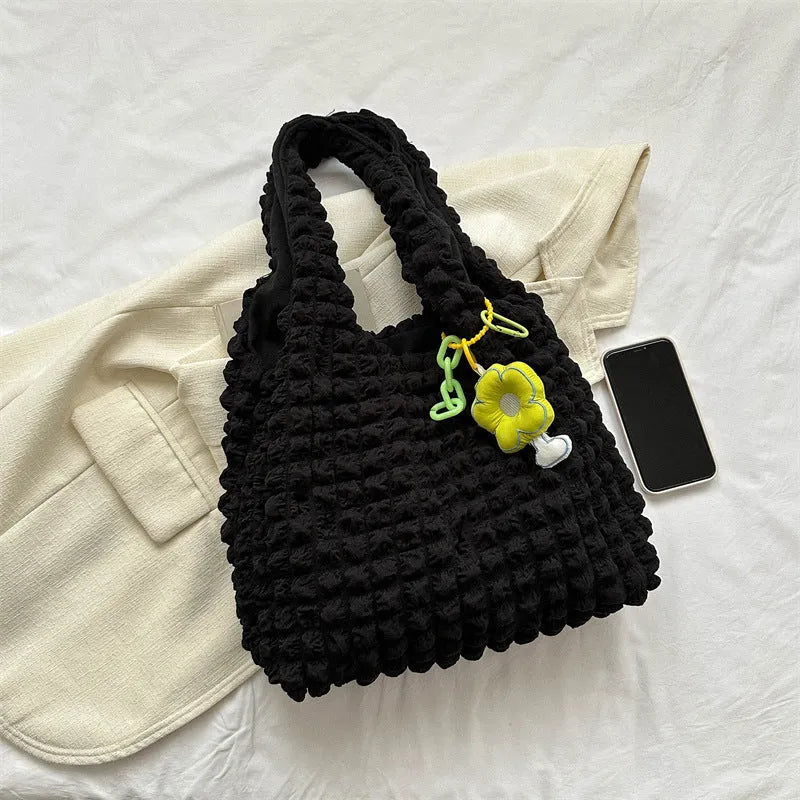 Women's pleated bubble shoulder bag with a floral pendant in soft polyester, shown in a vertical square shape.