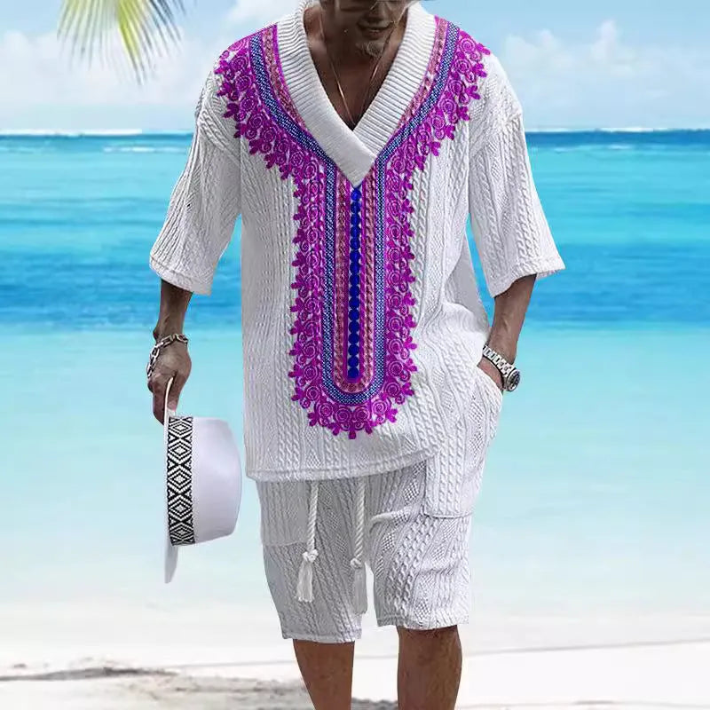 Man modelling a printed drop-shoulder knitted short-sleeved top with matching shorts in a casual setting.