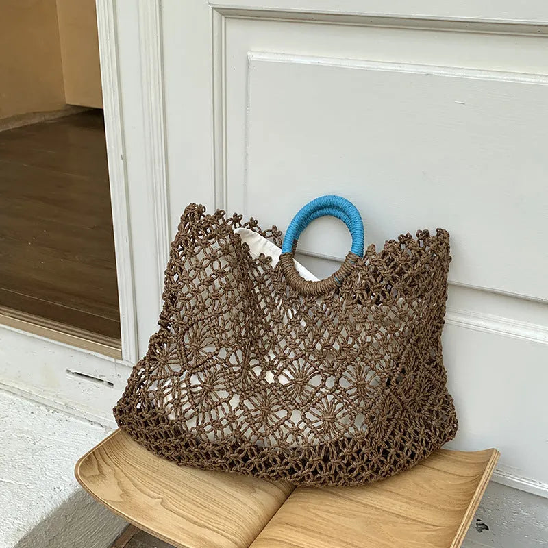 Dark brown handmade straw tote bag with square vertical shape and sandwich pocket design