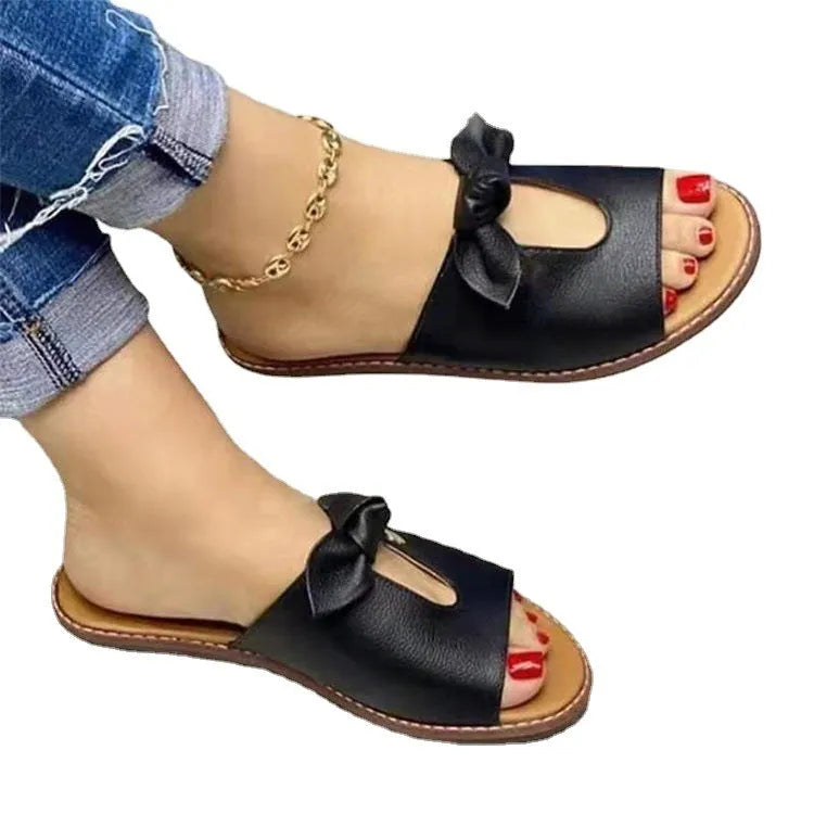 Women's black fish-mouth sandals with a decorative bow on the upper.