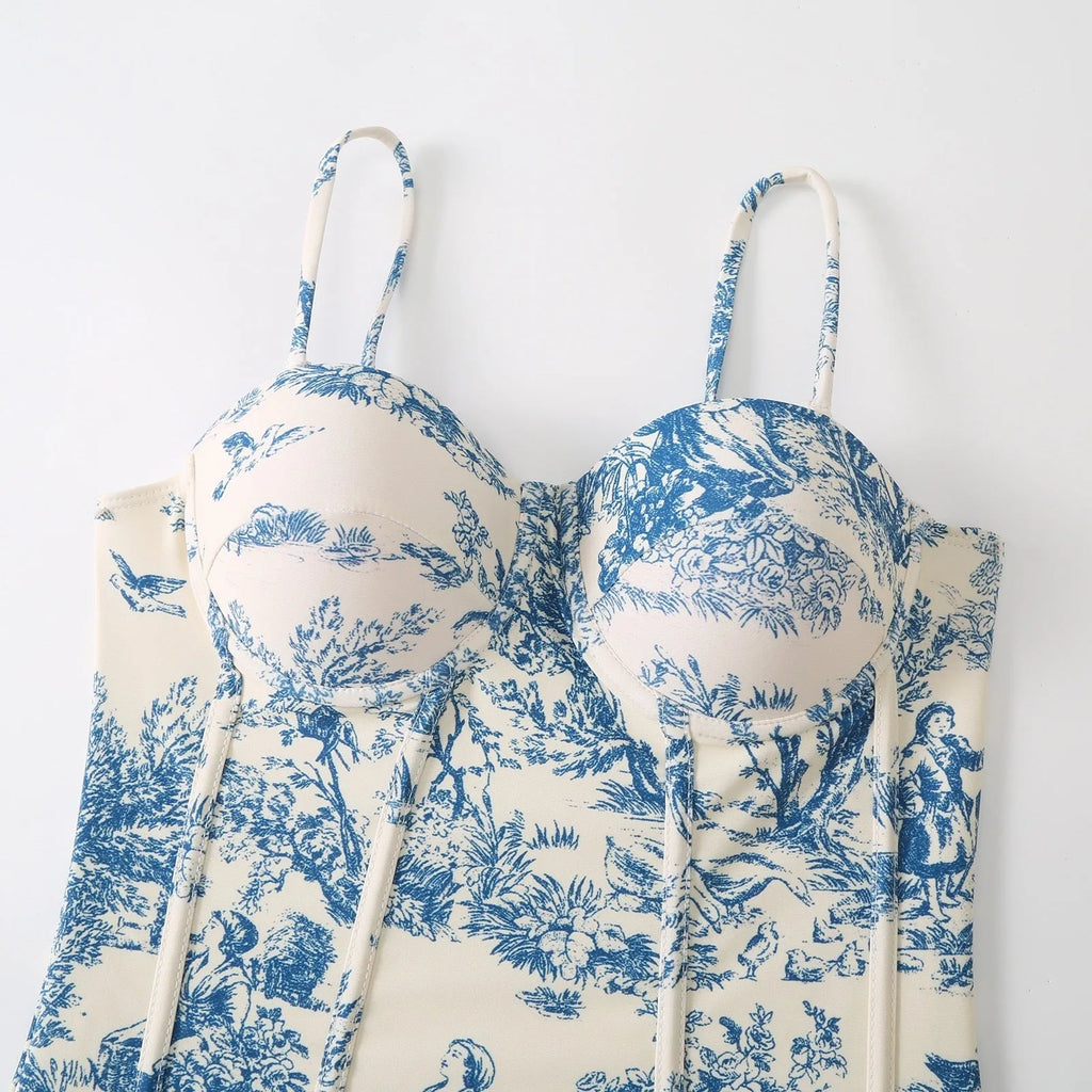 Blue women's one-piece swimsuit with a matching separate gauze skirt on a hanger.