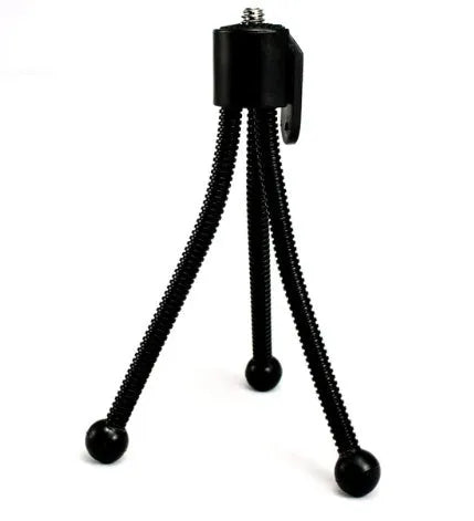 Small iron frame mini tripod with hose-style legs folded, compatible with Apple iPhone.