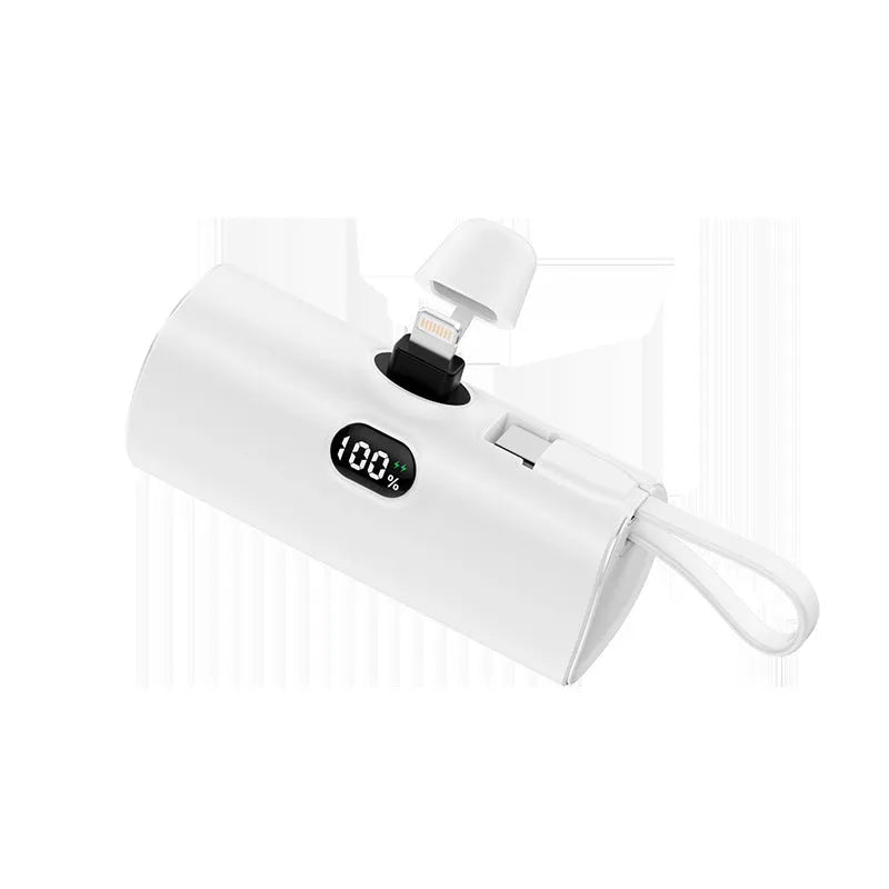 Compact capsule-shaped wireless power bank with digital display showing battery percentage.