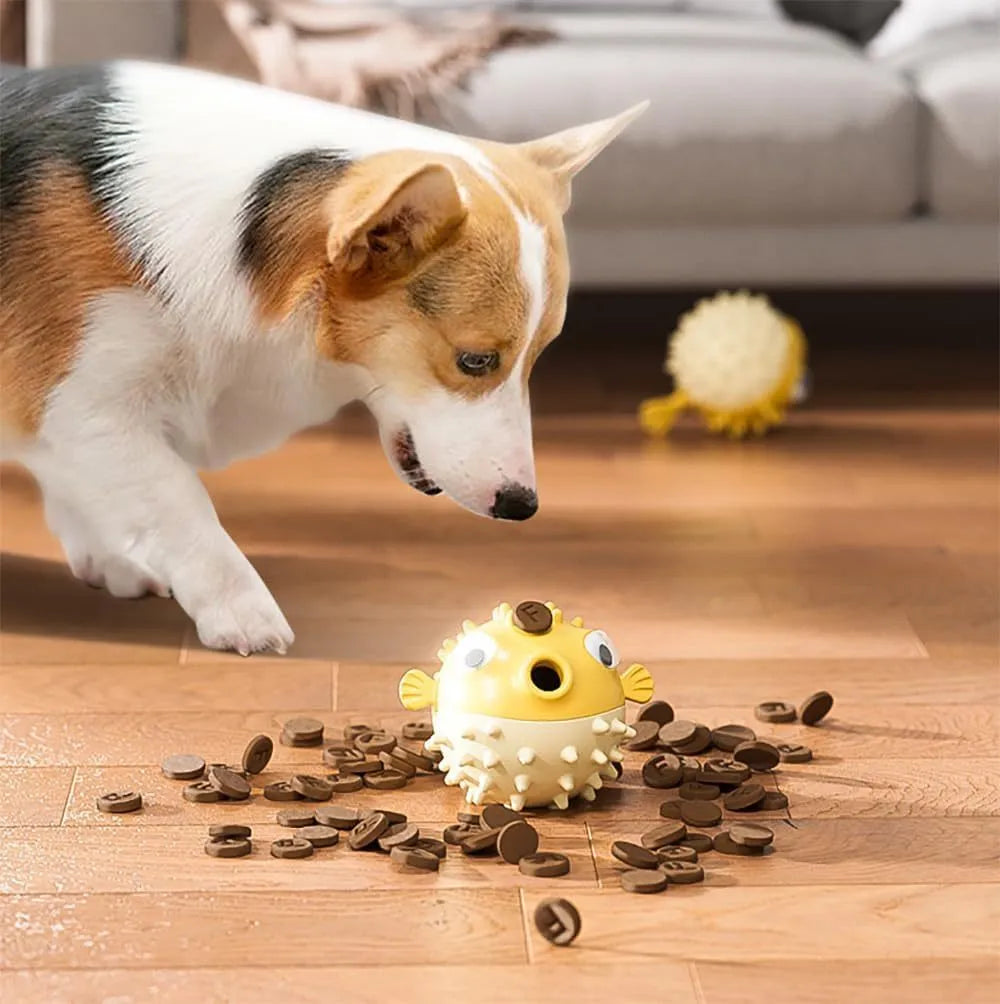 Green fish-shaped dog chew toy with textured surface, shown next to dog treats.