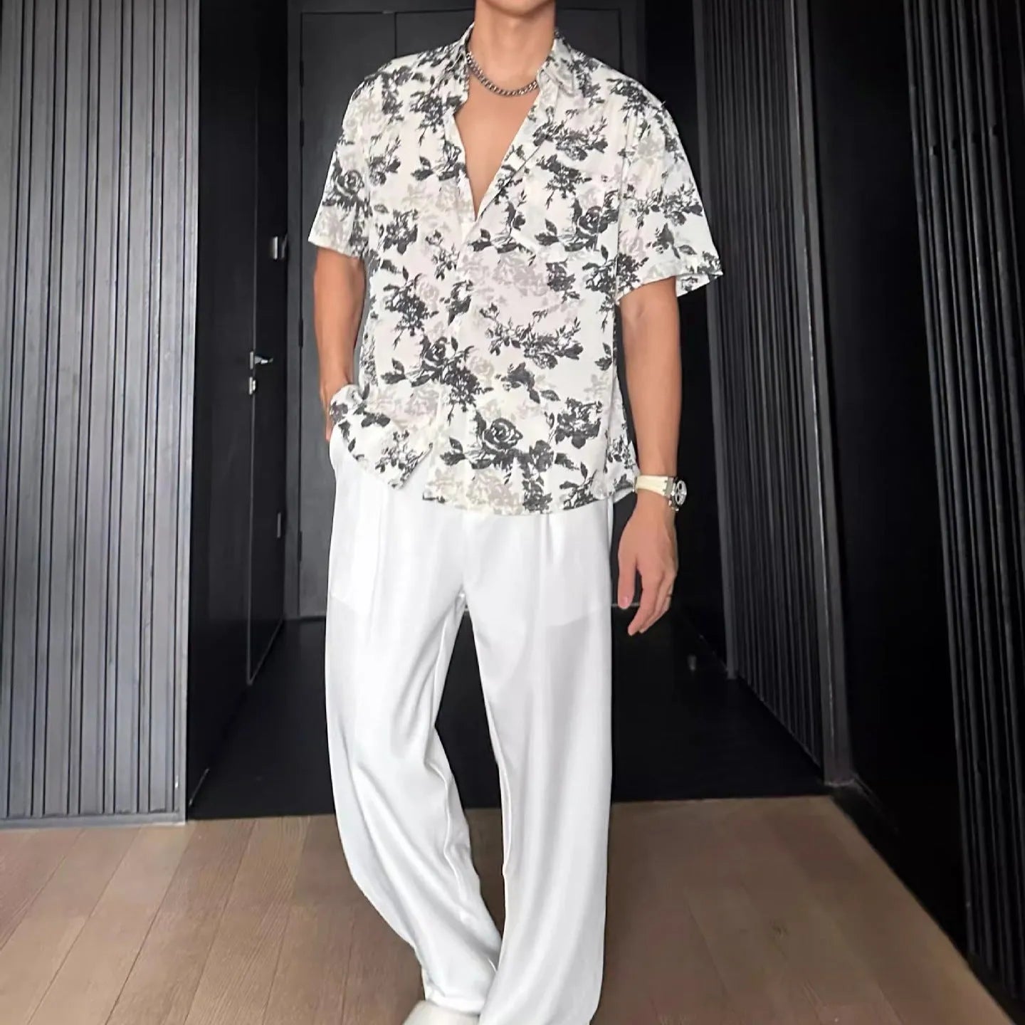 Loose fit short sleeve floral print shirt in white, shown on a hanger.