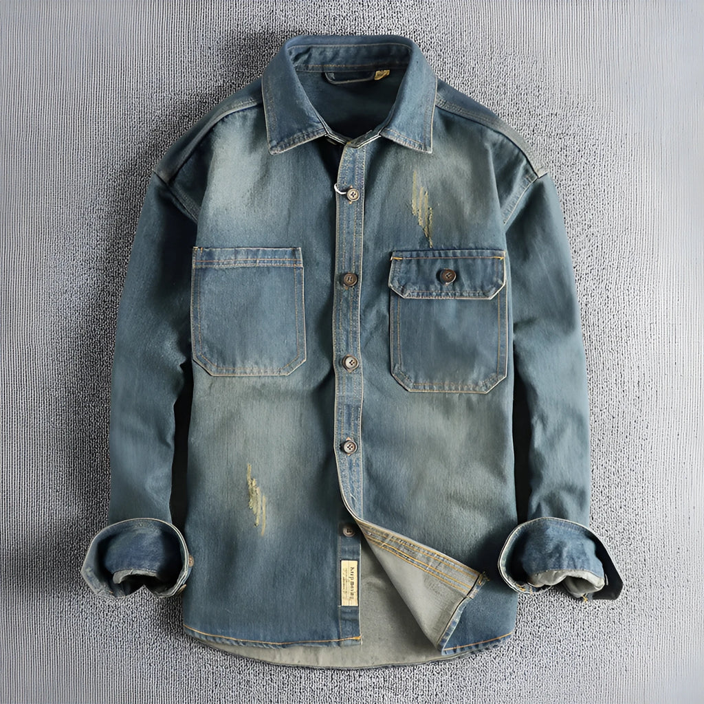 Men's light blue loose-fit vintage denim shirt with long sleeves on a hanger.
