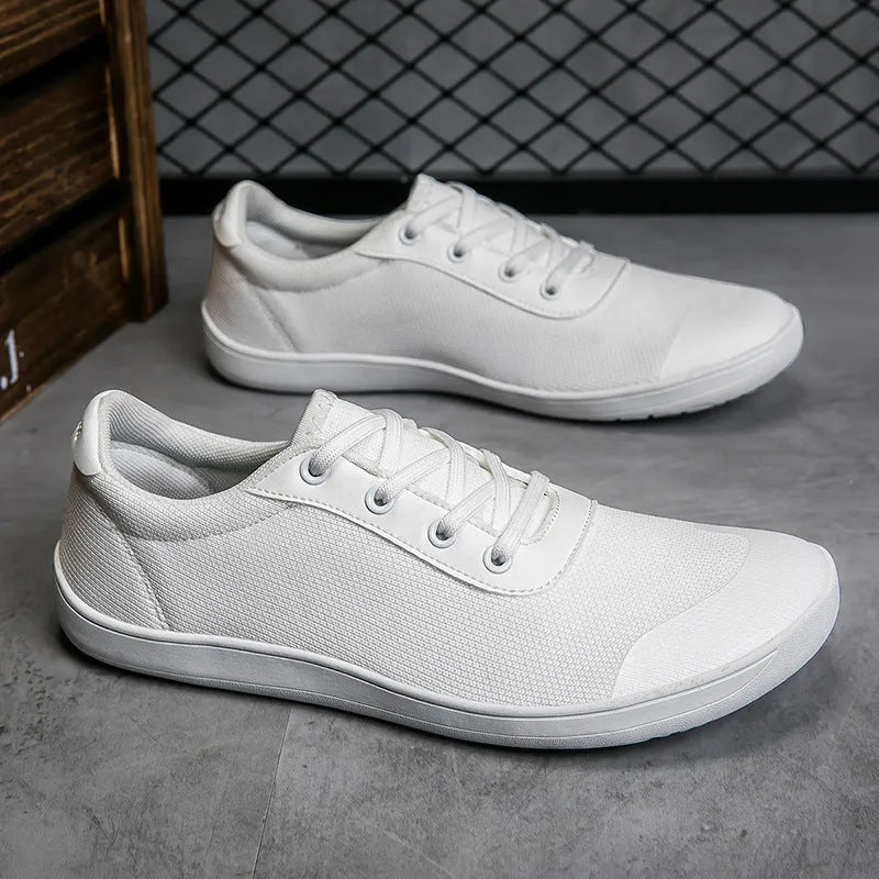 Men's solid-colour training shoes with a mesh upper, wide fit, and ribbed non-slip sole.