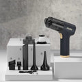 Black wireless car vacuum cleaner with multiple nozzle attachments and USB charging cable