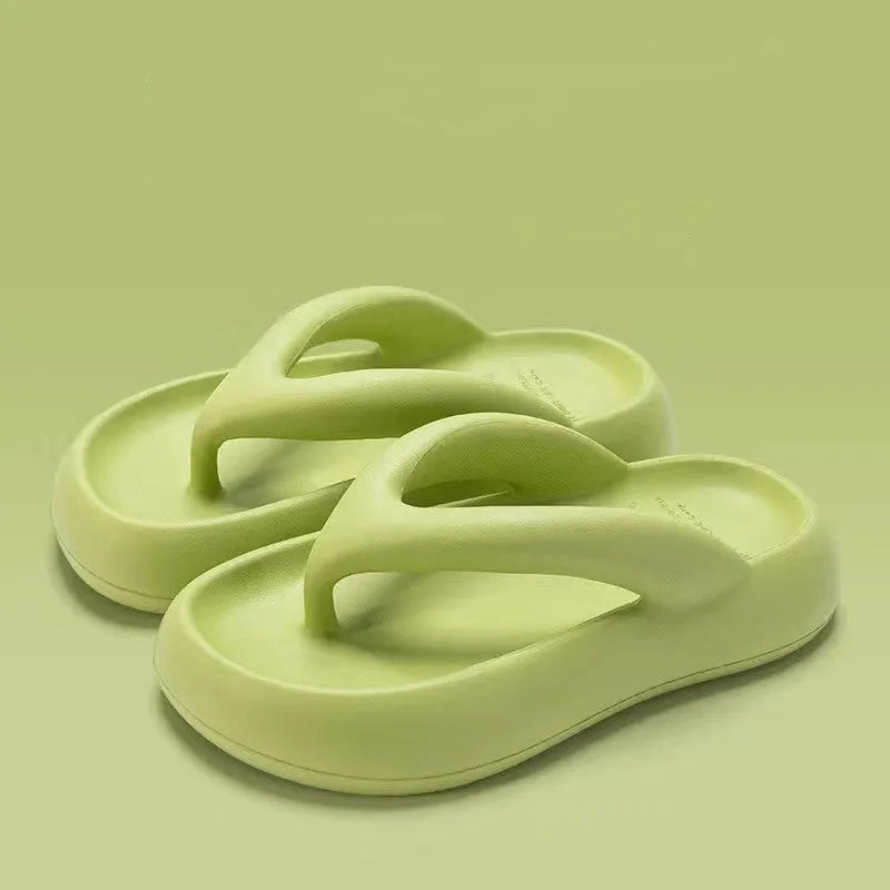A pair of solid-colour thick-soled EVA flip-flops with a decorative bow on the thong strap.