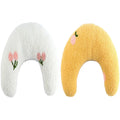 Small white U-shaped plush pillow for a cat or small dog, showing its half-donut shape with a raised rim.