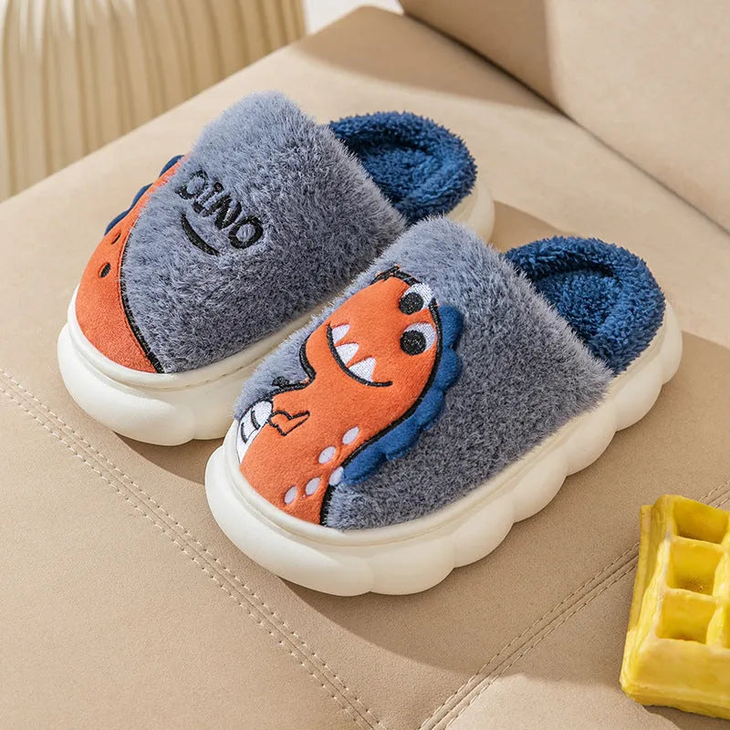 A pair of thick plush couple slippers with dinosaur graphics in coffee, grey, or orange colours.