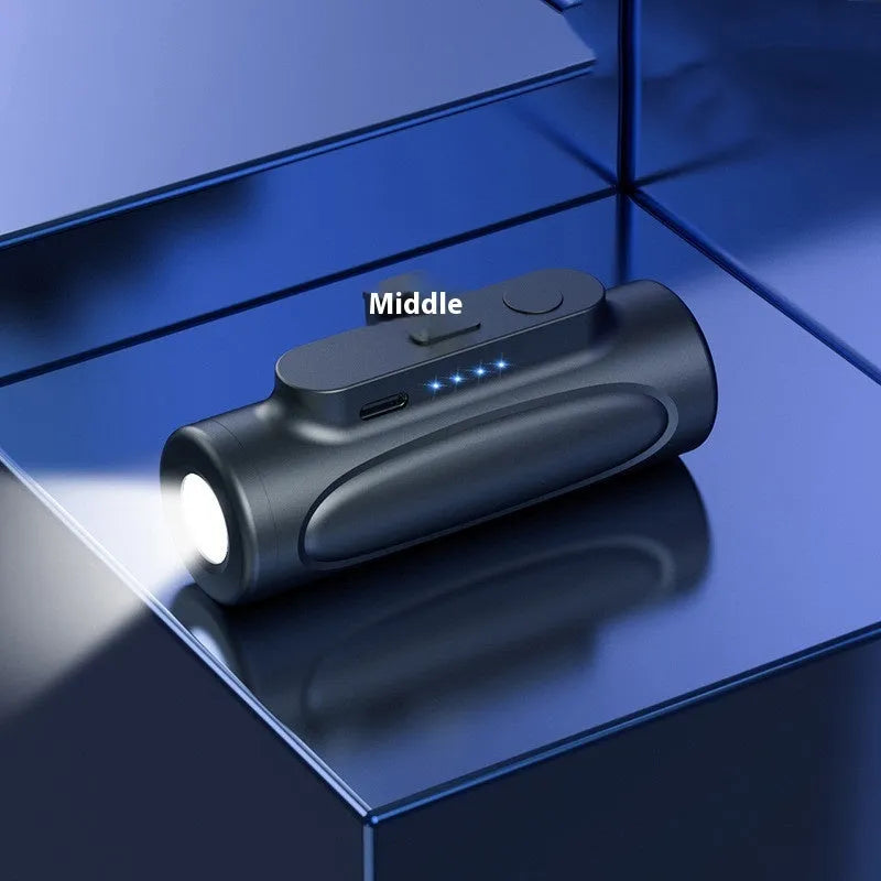 Black Creative Power Bank Glare Flashlight showing LED light on and compact 83mm size next to a mobile phone.