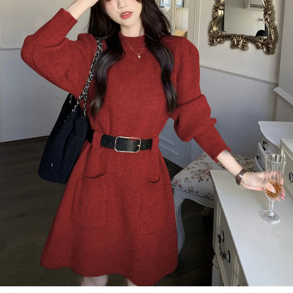 Women's beige loose knitted long sleeve dress with high waist and a black belt.