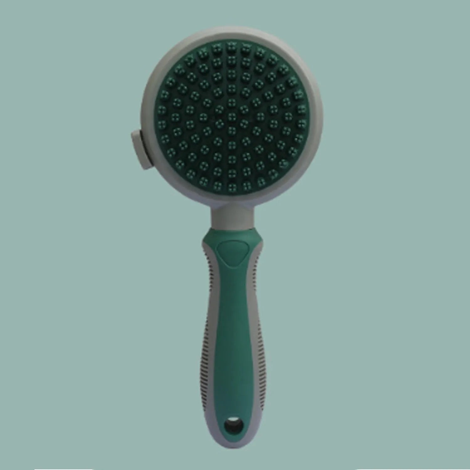 Pink and green double sided cat grooming brush showing slicker brush and flea comb sides with release button.