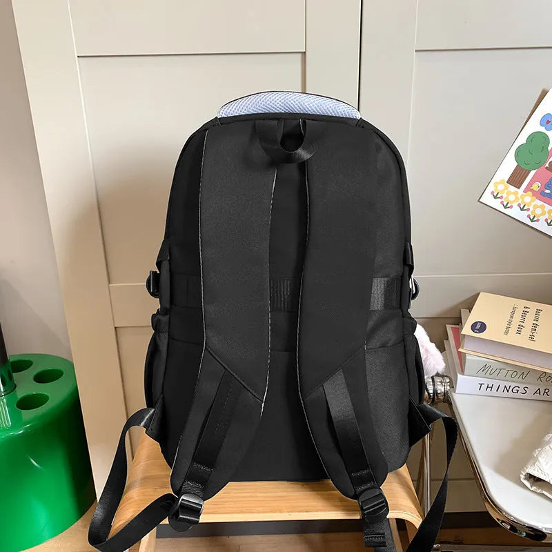 Waterproof nylon school backpack in colour options with curved shoulder straps and pendant attachment