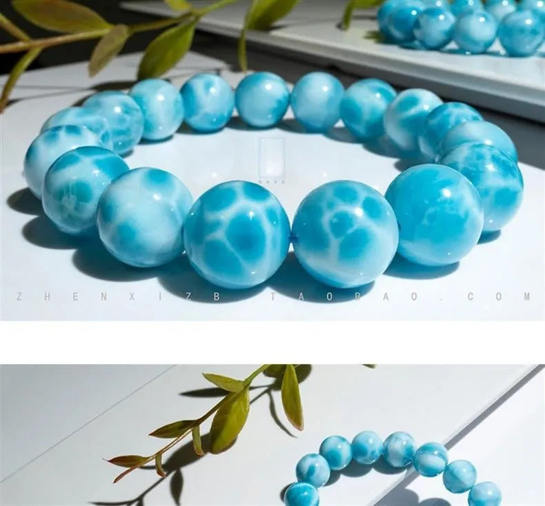 Blue bodhi bracelet with a sea-pattern natural crystal stone and small pearl accents on a wrist.