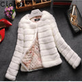 Women's short-length faux fur top in beige colour on a model, showcasing its textured fabric and regular sleeves.