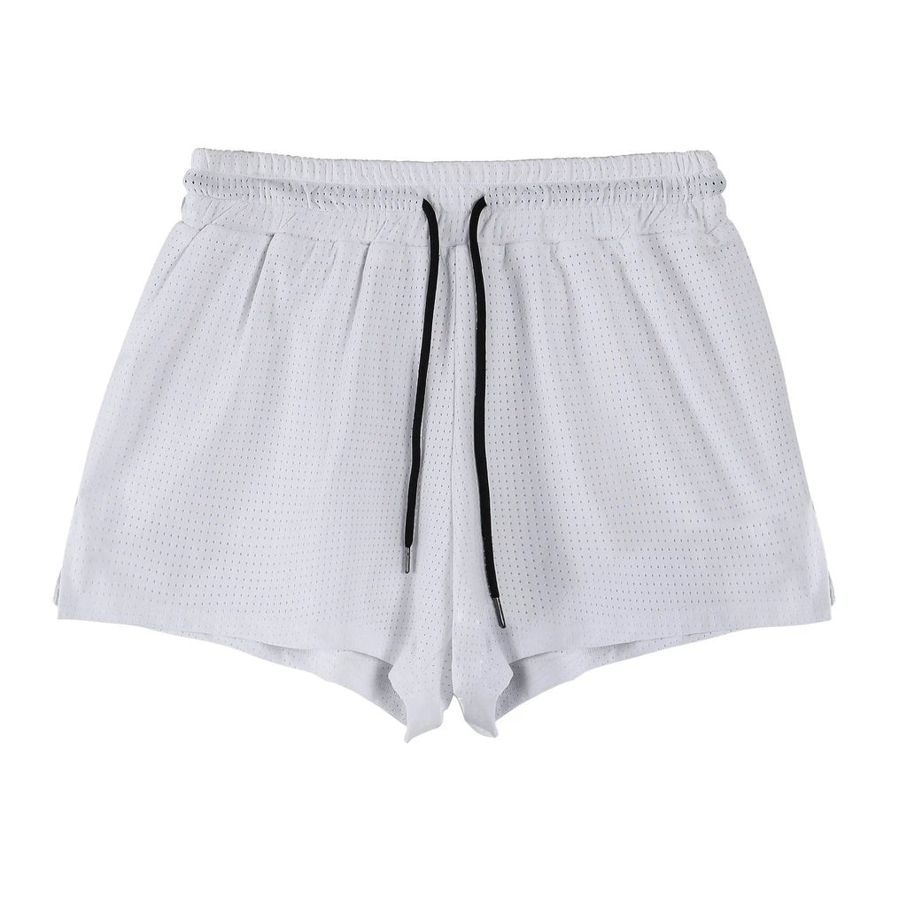 Man wearing black quick-dry nylon summer shorts on a light background
