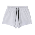 Man wearing black quick-dry nylon summer shorts on a light background