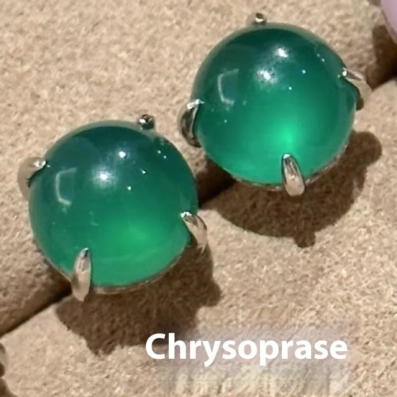 Chalcedony stud earrings with round egg surface design and four-claw settings in copper
