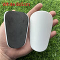 Extra small mini football shin guards in black and white, measuring 8x5cm