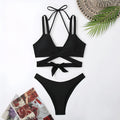 Women's solid colour strap bikini swimsuit on a mannequin, shown in black.
