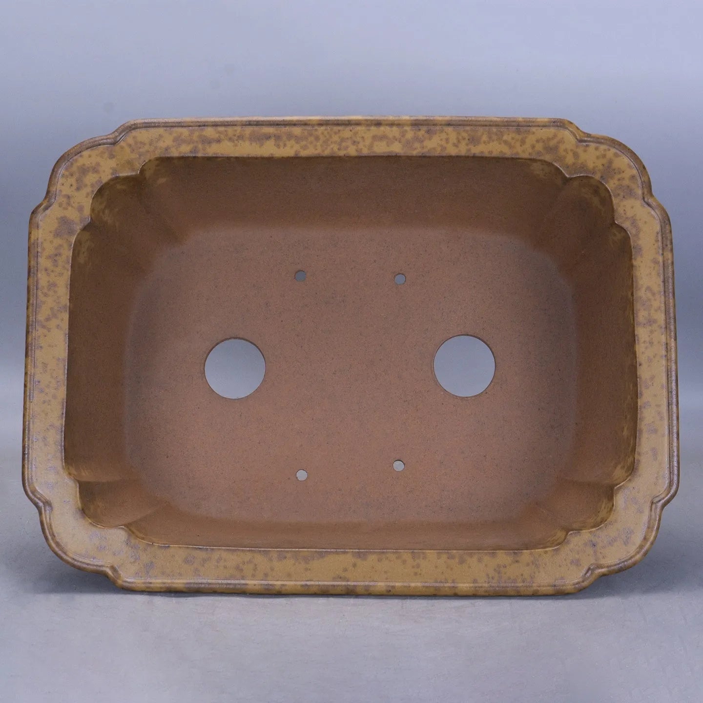 Modern rectangular purple sand floor planter with a visible water level gauge on its side.