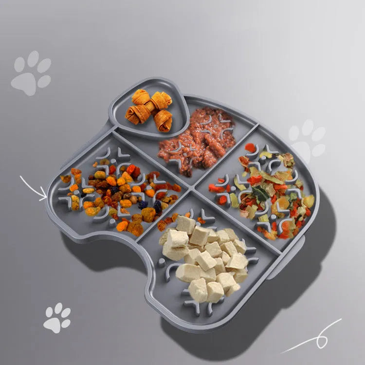 Gray silicone pet slow food pad with suction cups on tile floor, textured surface for licking