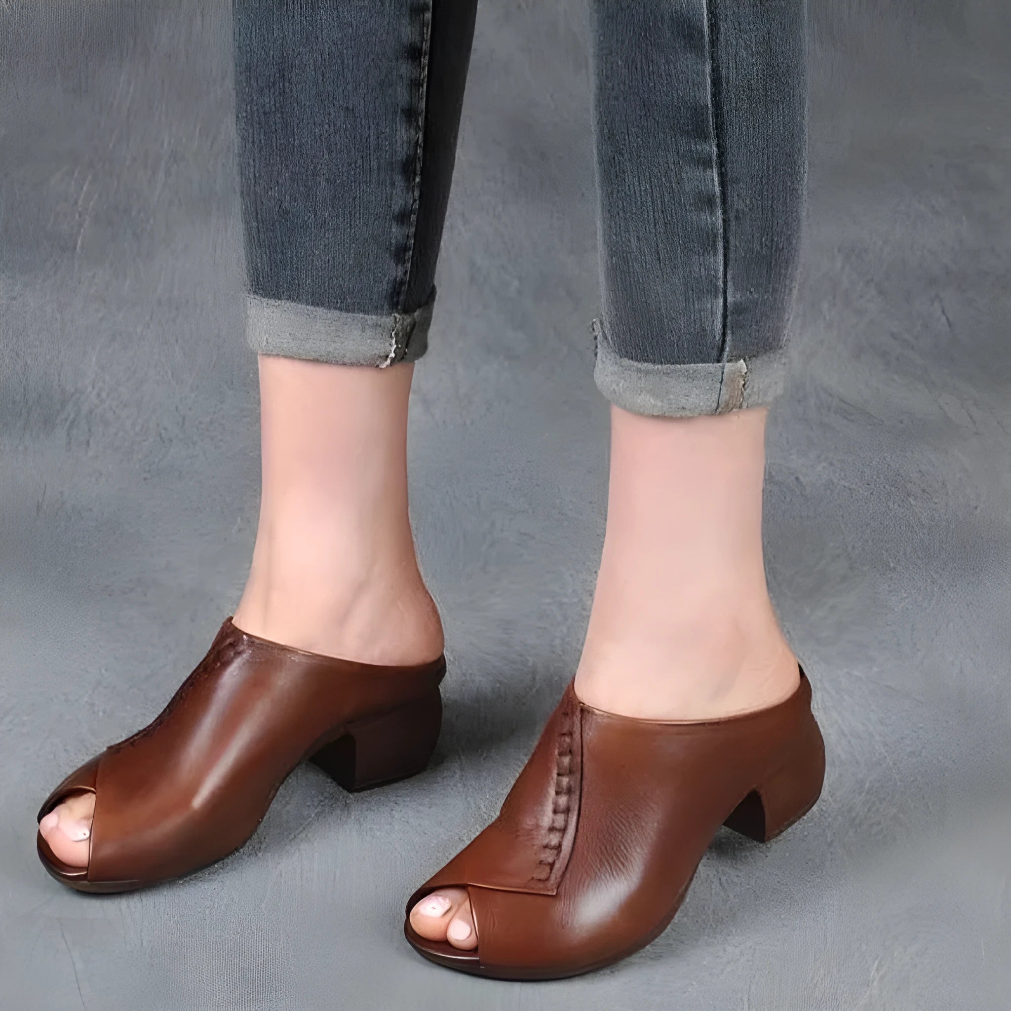A pair of women's black square heel peep-toe slippers with an open fish mouth design.