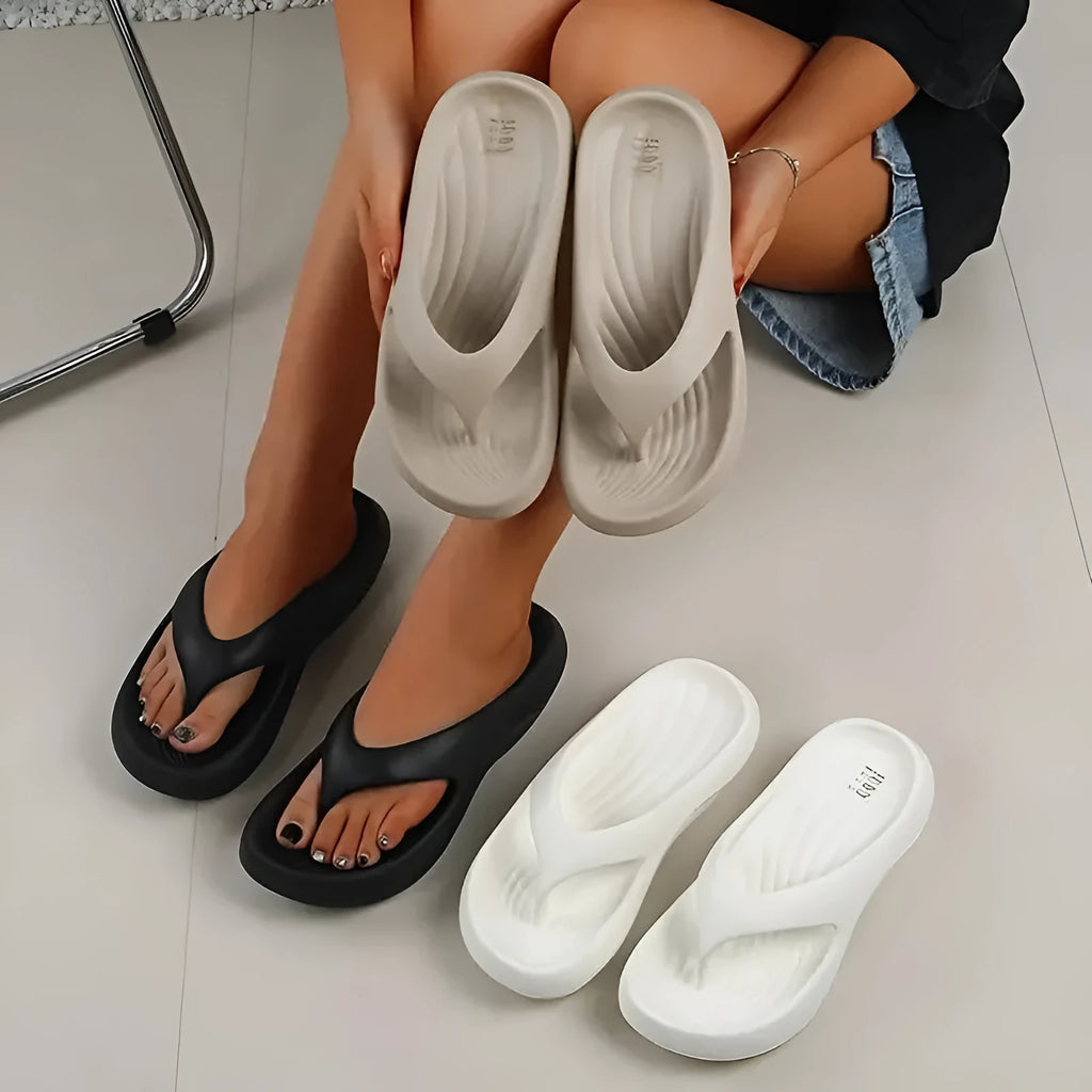 Women's black thick-soled EVA flip-flops with a non-slip sole design.