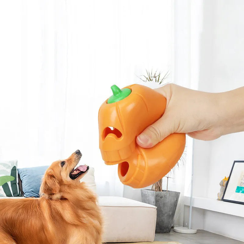 Orange Halloween pumpkin shaped dog chew toy with a black treat-dispensing funnel on top.
