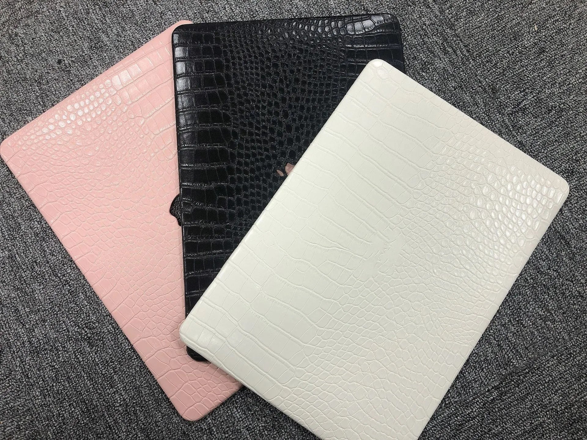 MacBook laptop protective case with leather pattern texture and hollowed-out Apple logo in black colour