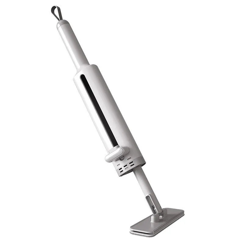 Pink self-squeezing rotatable mini flat mop with microfiber pad on a hardwood floor.