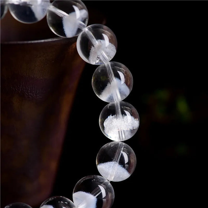 Women's white crystal pyramid bracelet with Ruyi charm showing natural ghost pyramid design