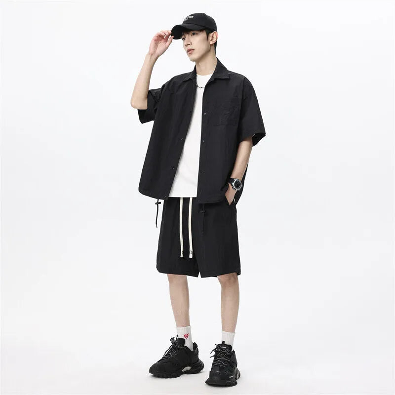 Men's loose casual shirt and matching shorts two-piece set in a light grey colour.