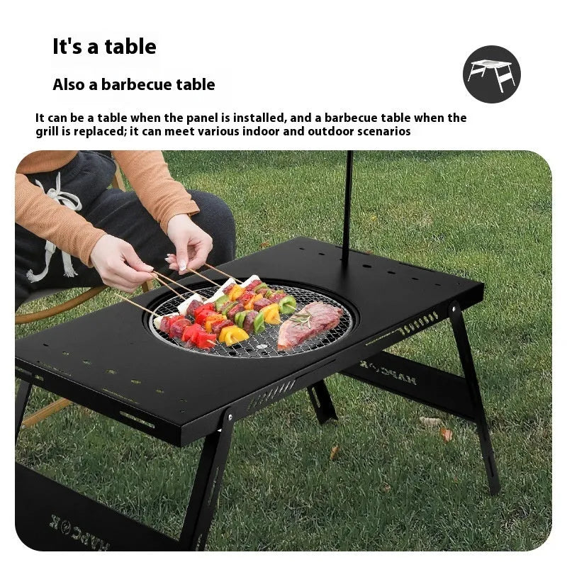 Folding camping cooking table with integrated barbecue surface in black