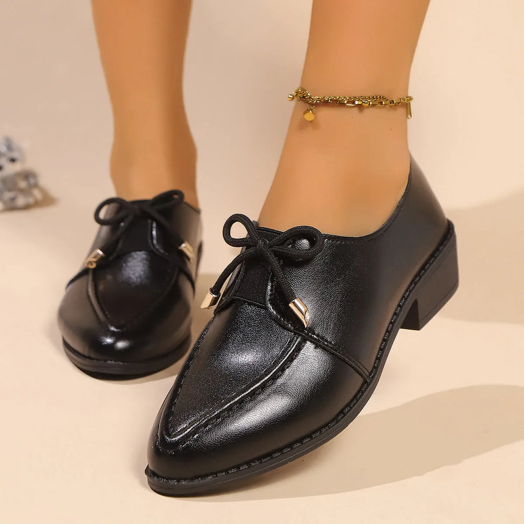 Women's British-style loafers with a bow detail on a PU upper and rubber sole.