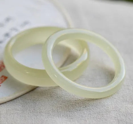 Ice-like silk jade round bar bracelet showing smooth stone surface and circular form