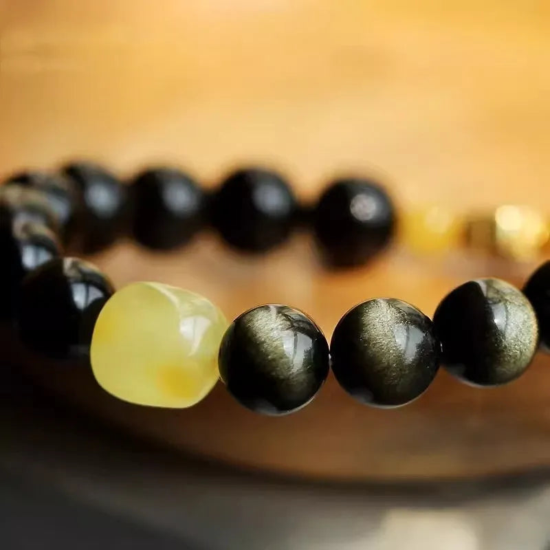Golden obsidian ethnic bracelet with zodiac symbols on geometric 10mm stones