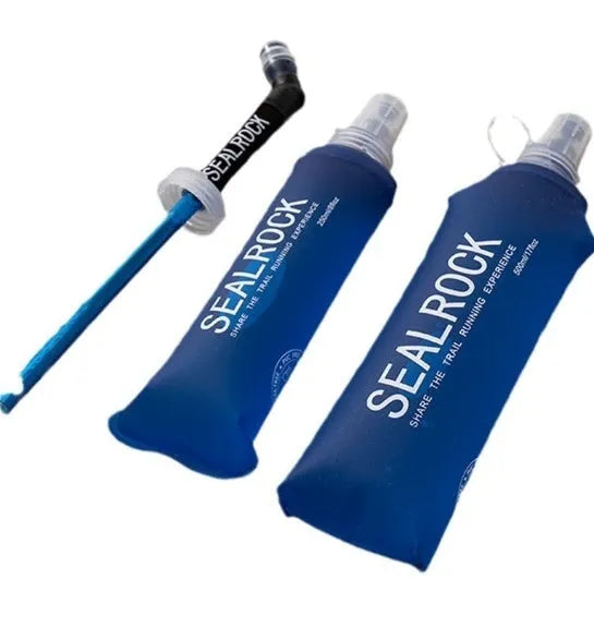 Flexible silicone drinking straw with black carabiner clip against outdoor background