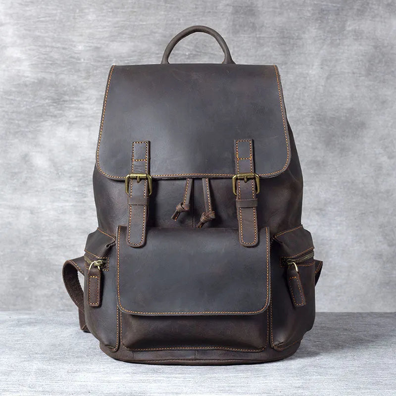 Brown crazy horse leather backpack with denim lining and double shoulder straps.