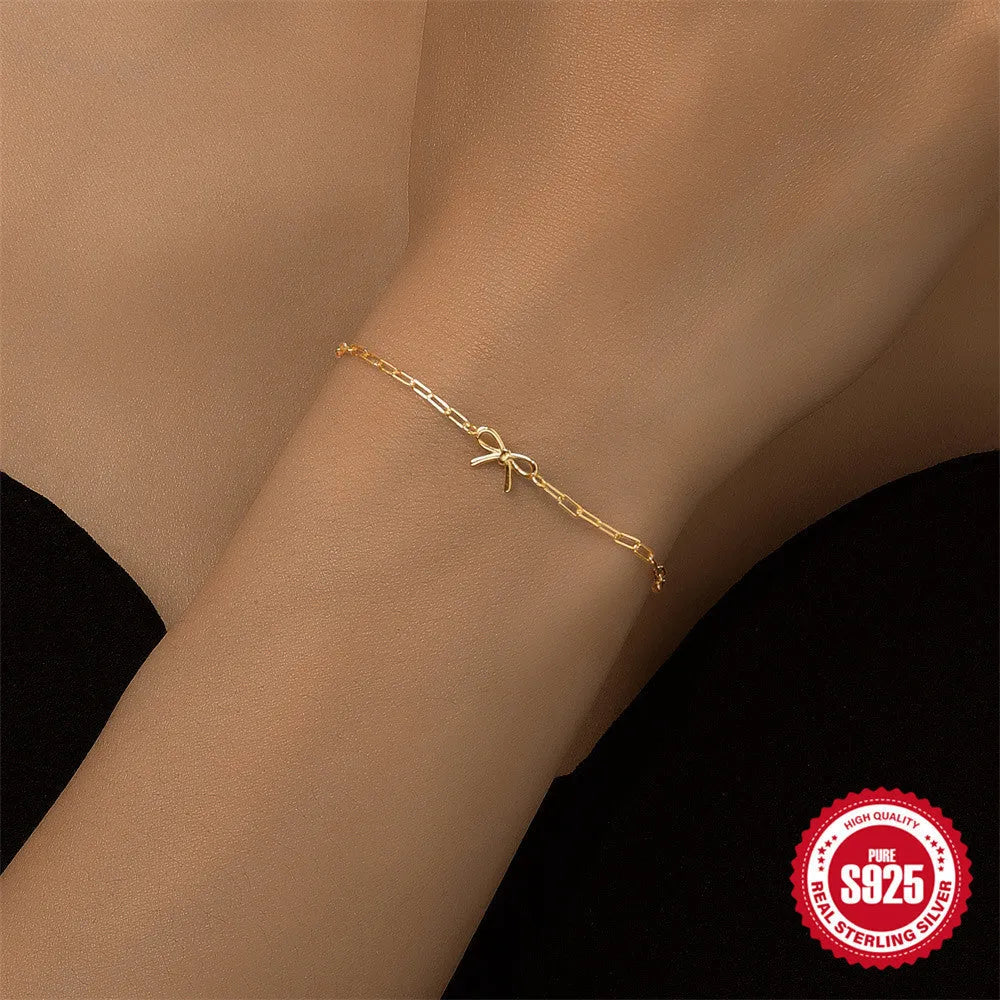 S925 sterling silver women's bracelet with glossy gold tone heart charm and lobster clasp closure