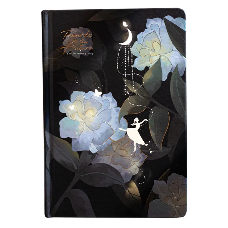 A5 notebook with a luminous cover shown in deep blue, open to reveal pages with colour illustrations.