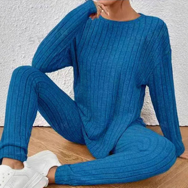 Black sunken stripe two-piece loungewear set with top and trousers on a hanger.
